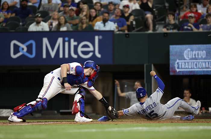 May 11, 2022; Arlington, Texas, USA; Kansas City Royals second baseman Whit Merrifield (15) scores ahead of the tag of Texas Rangers catcher Sam Huff (55) during the ninth inning at Globe Life Field.